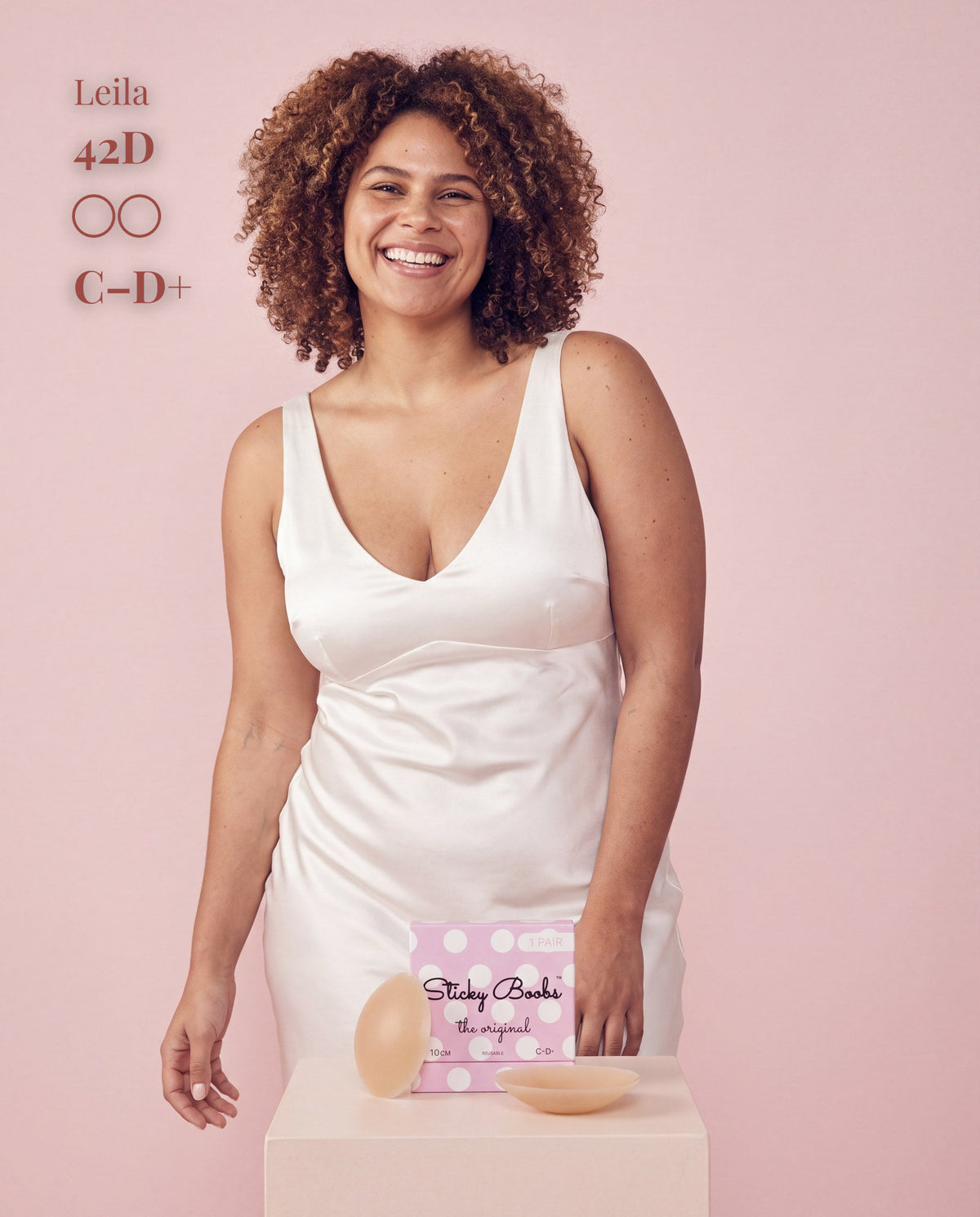 The Original Sticky Boobs, Tan shade, size C-D+ (10cm) — model with adhesive nipple covers and box 