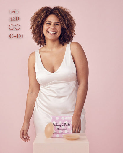 The Original Sticky Boobs, Tan shade, size C-D+ (10cm) — model with adhesive nipple covers and box 